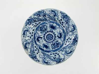 Appraisal: A Chinese blue and white spiral-moulded dish painted with panels