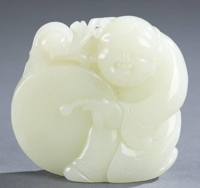 Appraisal: Chinese carved jade figure boy playing drum A Chinese carved