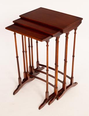 Appraisal: A nest of three rectangular mahogany tables on spindle turned