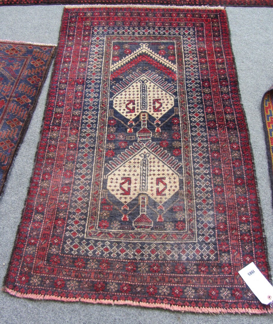 Appraisal: A Beluchistan prayer rug the indigo mehrab with two ivory