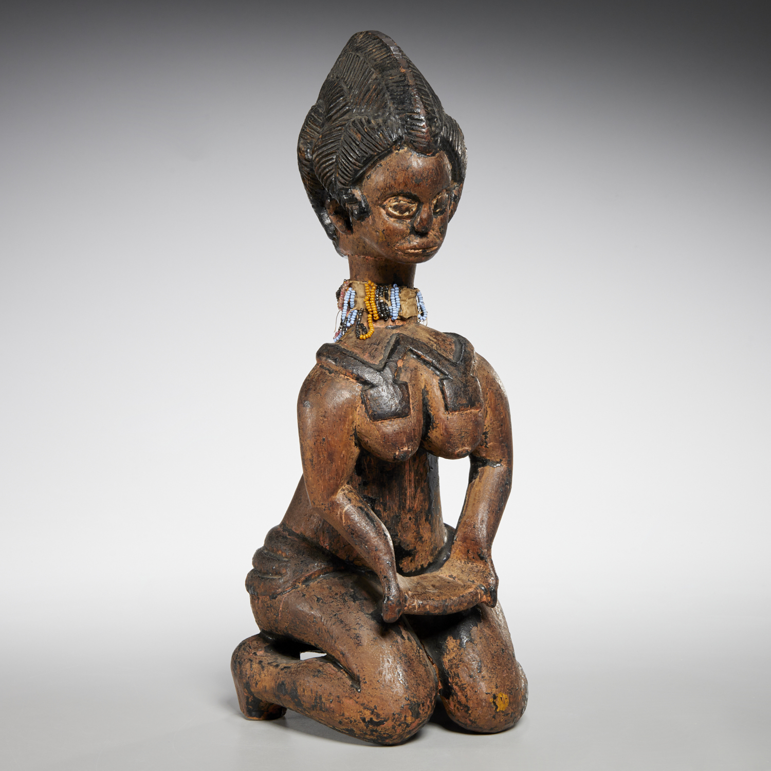 Appraisal: BAGA PEOPLES KNEELING FEMALE FIGURE likely th c Guinea carved