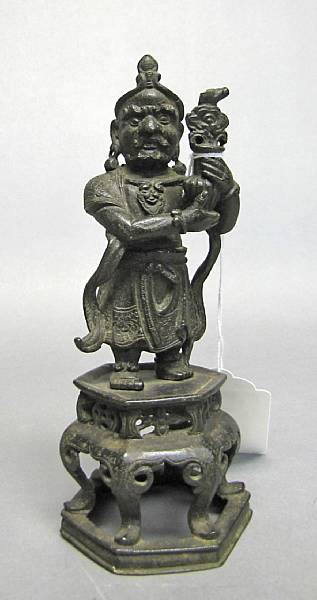 Appraisal: A bronze Buddhist guardian figure th Century The stocky figure