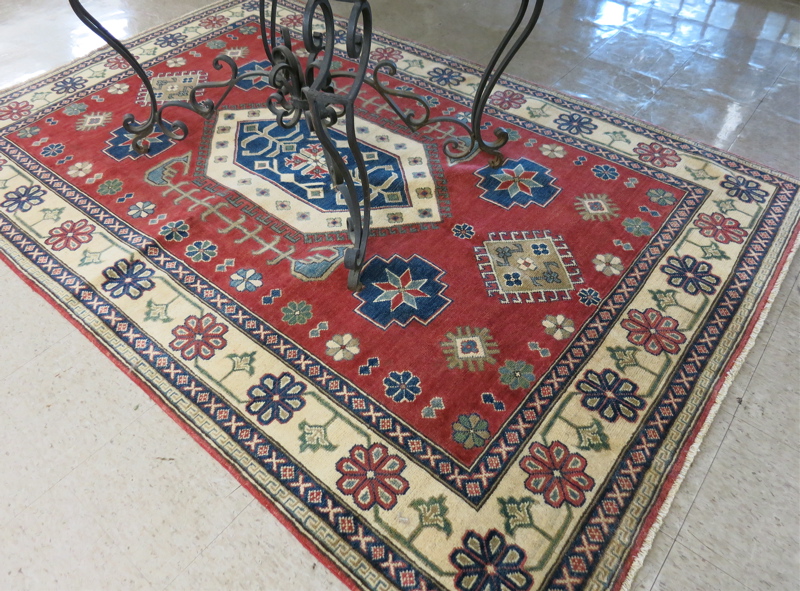 Appraisal: HAND KNOTTED ORIENTAL CARPET Pakistani Caucasian geometric and stylized floral