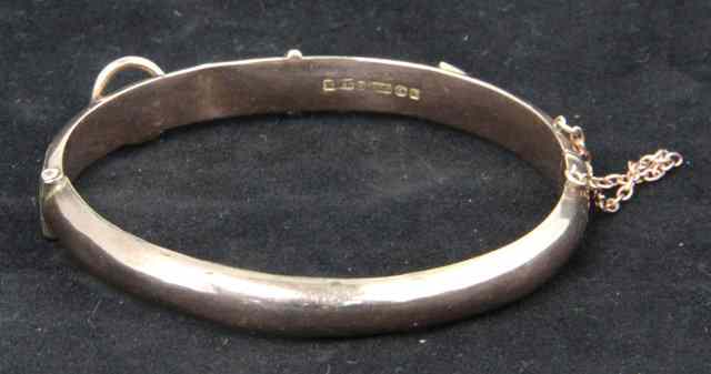 Appraisal: A ct gold bangle of belt form with engraved decoration