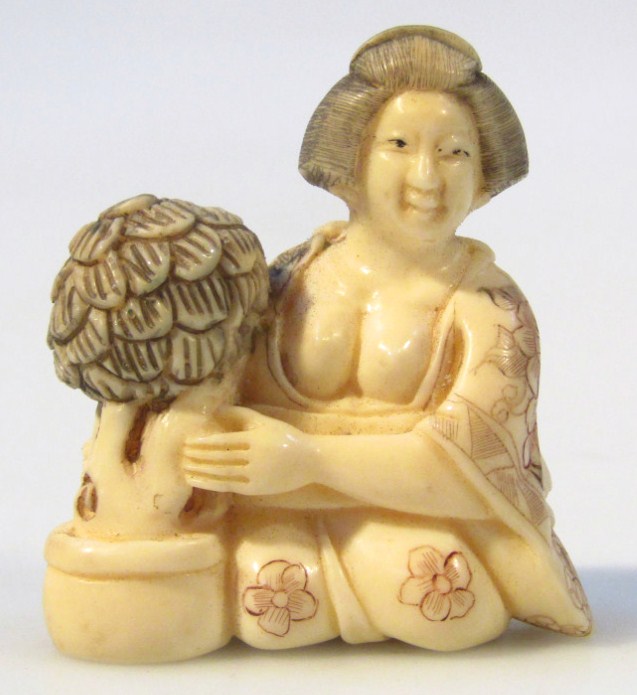 Appraisal: A Japanese Meiji period erotic ivory netsuke formed as a