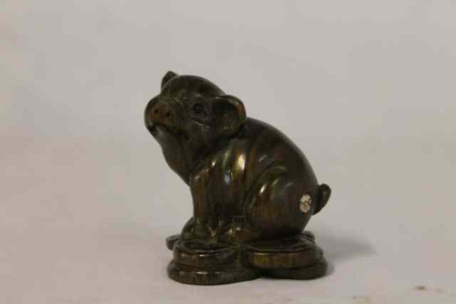 Appraisal: A JAPANESE CARVED WOOD NETSUKE in the form of a