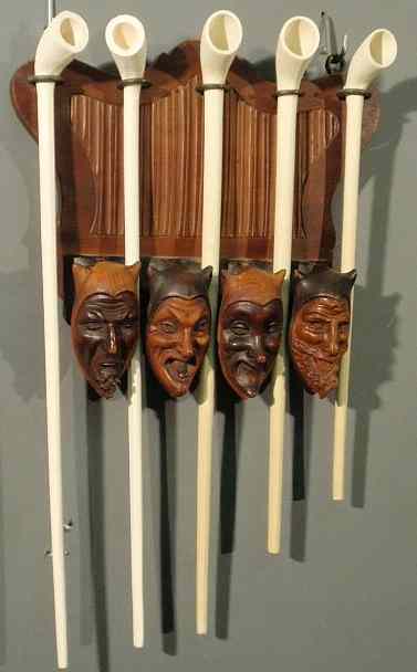 Appraisal: Continental carved walnut pipe rack with figural heads and five