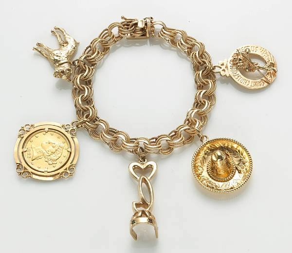 Appraisal: A k gold charm bracelet suspending five charms including a