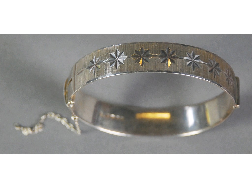 Appraisal: SILVER BROAD BANGLE hinge opening with bright cut engraved star