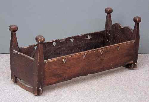 Appraisal: An old stained wood rocking crib with square bulbous knop