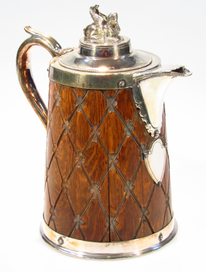 Appraisal: An Edwardian oak and silver plated tankard the tapering cylindrical