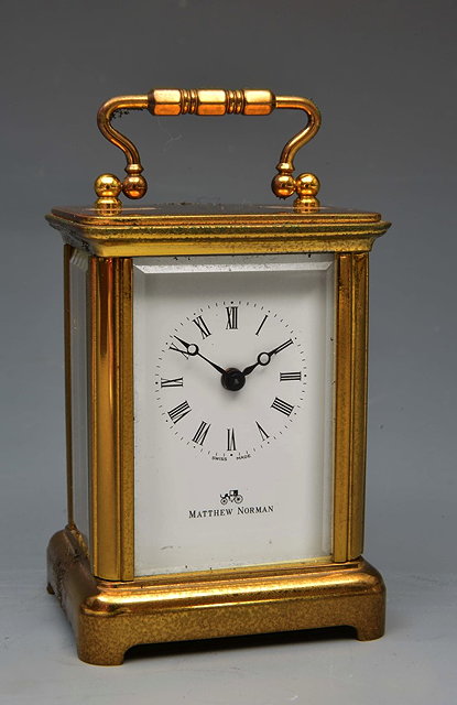 Appraisal: A MATTHEW NORMAN MINIATURE CARRIAGE TIMEPIECE with white enamel Roman