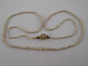 Appraisal: A graduated seed pearl necklace with pearl set yellow metal