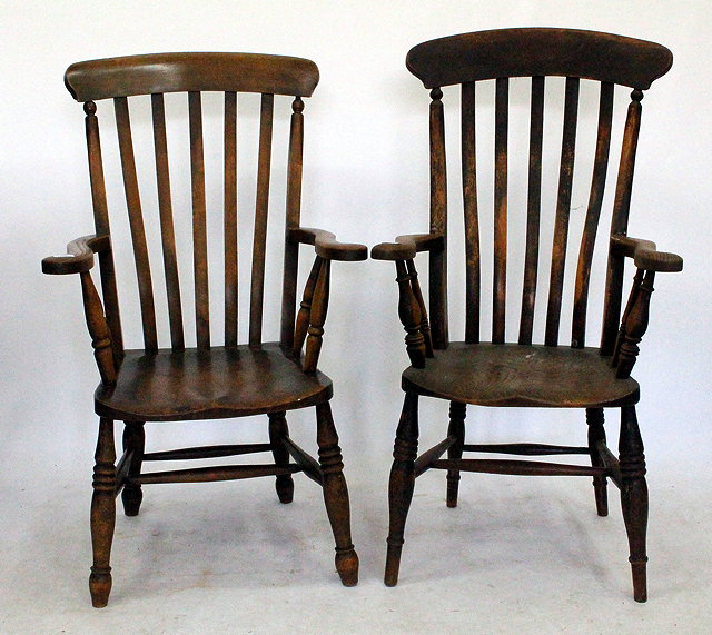 Appraisal: A PAIR OF ELM COUNTRY ARMCHAIRS with spindle sides and