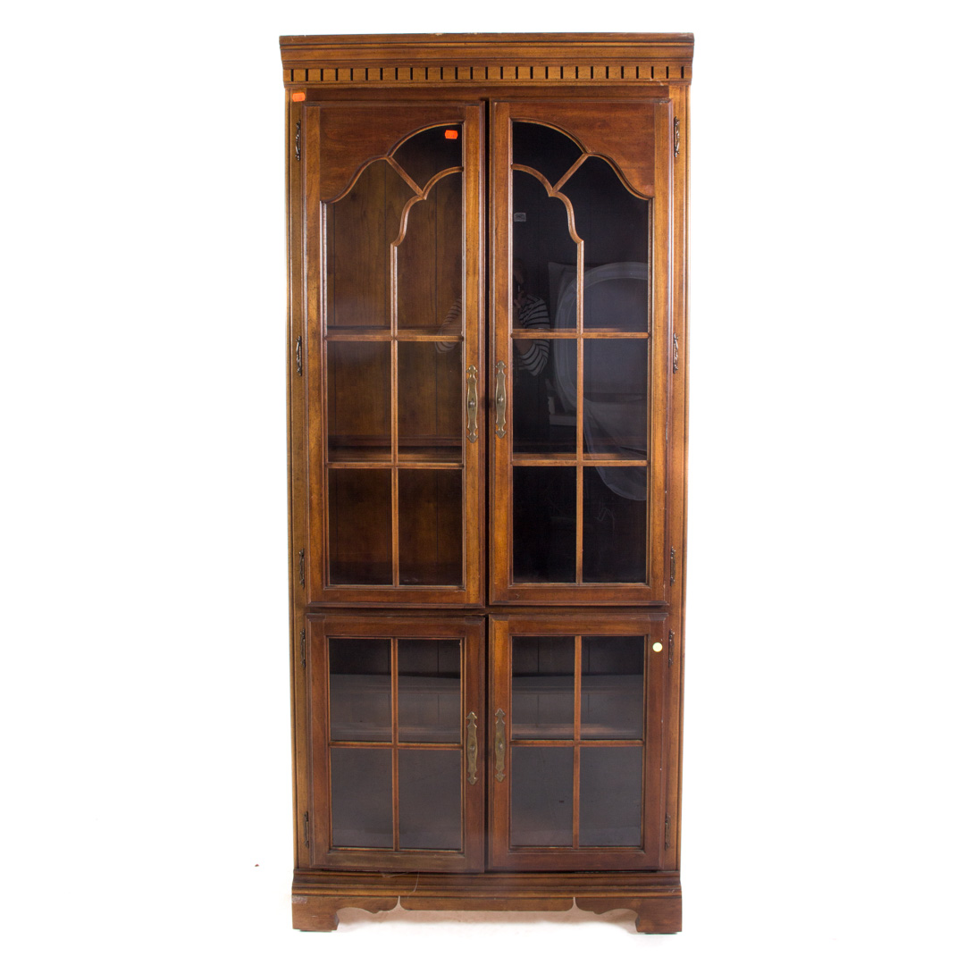 Appraisal: Traditional style fruitwood display cabinet glass panel doors in H