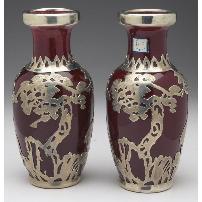 Appraisal: Unusual Asian vases pair crimson glaze applied silver overlay with