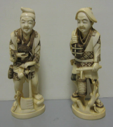 Appraisal: TWO JAPANESE CARVED IVORY AND INKED FIGURES One man holding