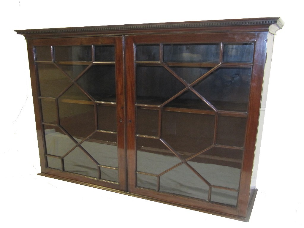 Appraisal: A Victorian mahogany bookcase top the two glass doors bearing