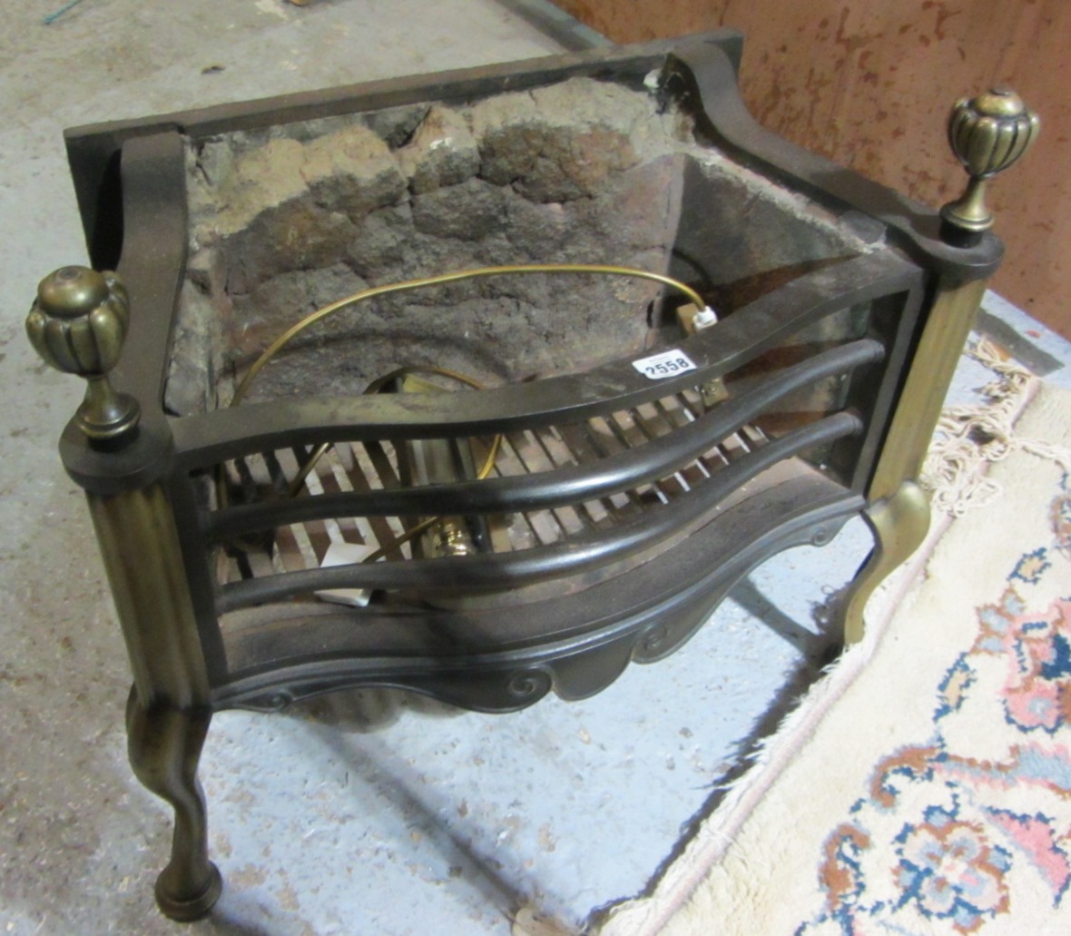 Appraisal: A brass and wrought iron fire basket and a smaller