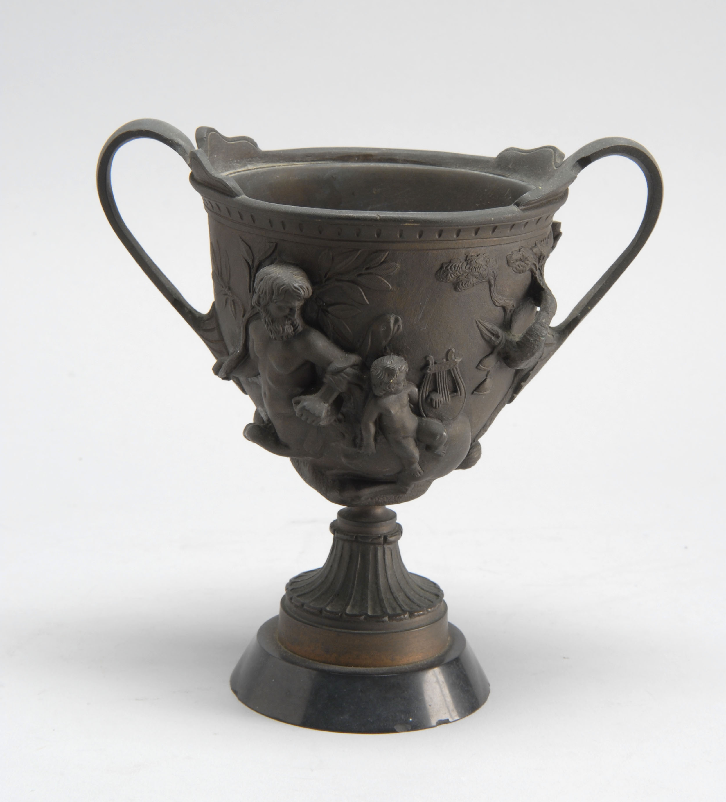 Appraisal: VICTORIAN BRONZE TWO-HANDLED URN with raised decoration of cherubs riding