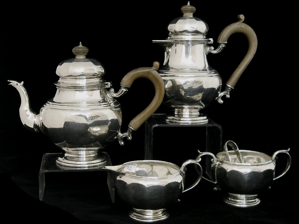 Appraisal: Four piece tea service of baluster faceted form upon a