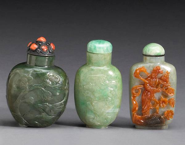 Appraisal: Three carved jade snuff bottles The first of flattened ovoid