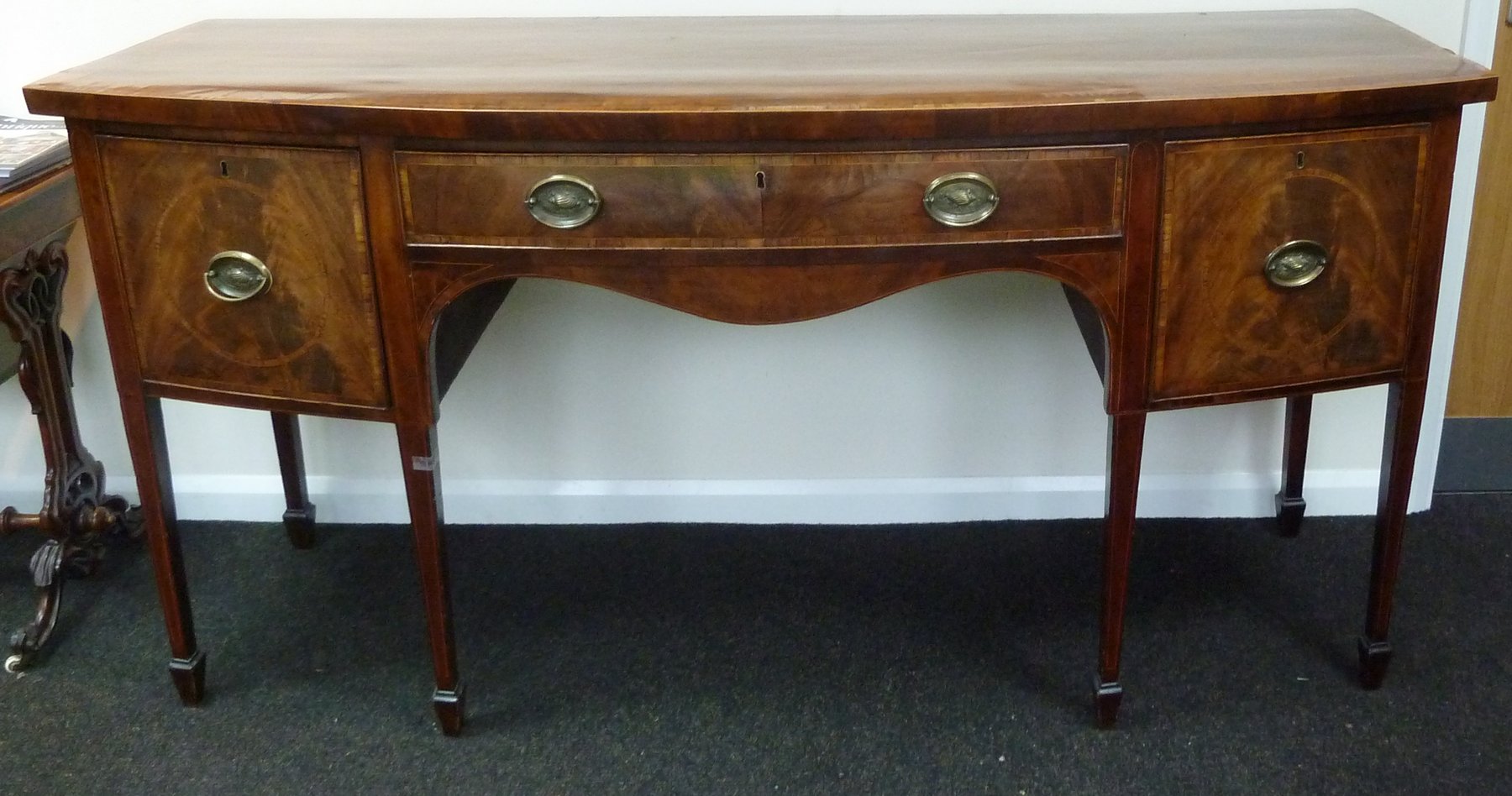 Appraisal: A George III mahogany bow fronted sideboard with cross banded