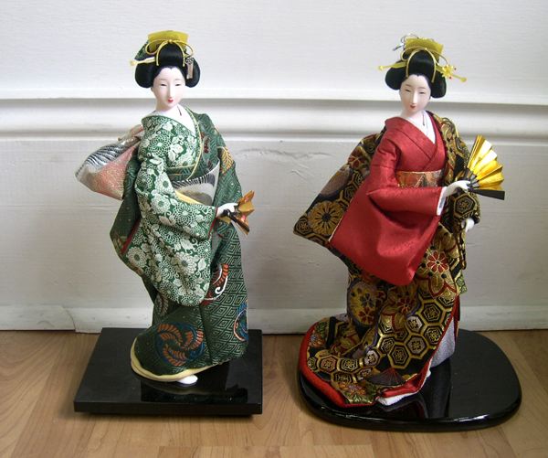 Appraisal: Pair of Japanese Richly Costumed Geisha Figures in tradition brocade