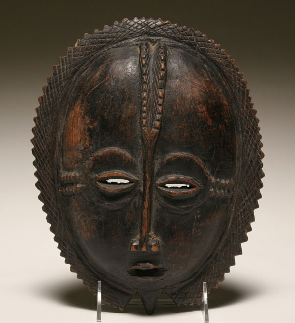 Appraisal: African Baule carved wooden mask serrated headpiece frames the face