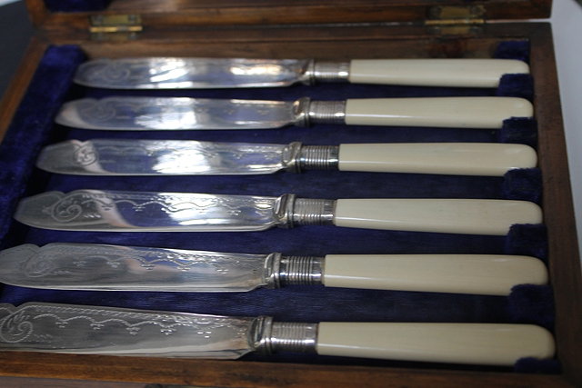 Appraisal: A CASED SET OF SILVER PLATED FISH KNIVES and forks