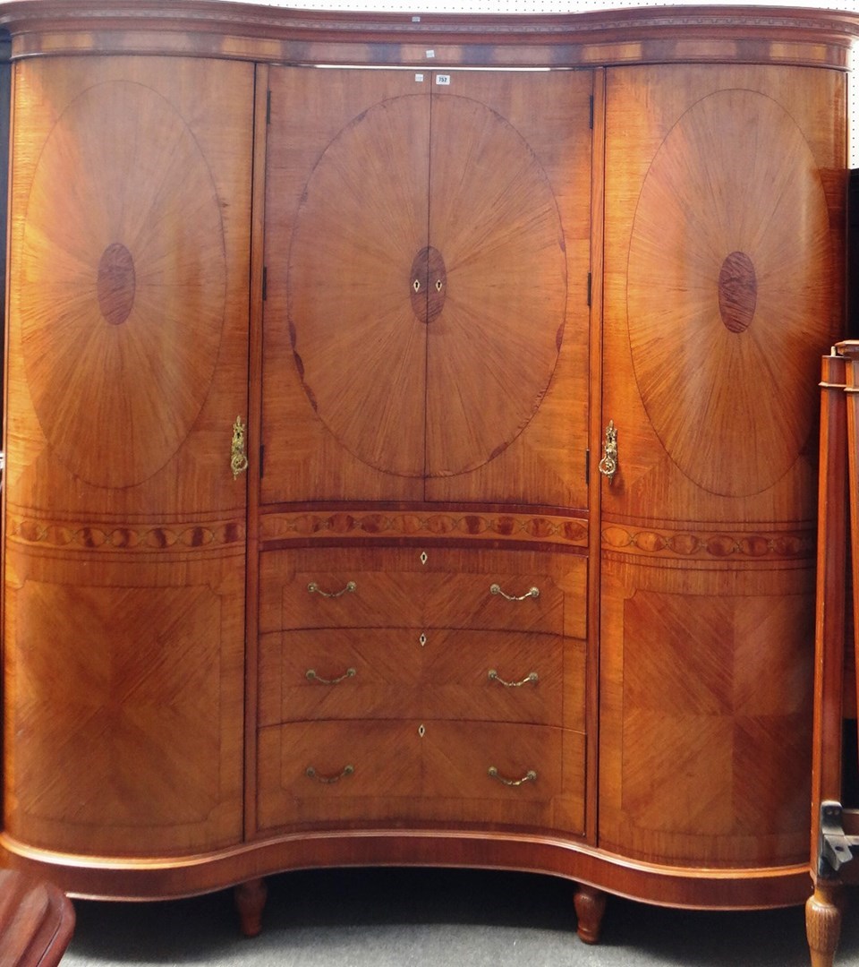 Appraisal: An early th century satinwood double bowfront compactium wardrobe with