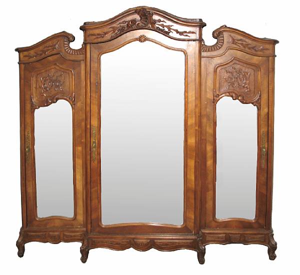 Appraisal: A Rococo style mixed wood wardrobe in three sections with