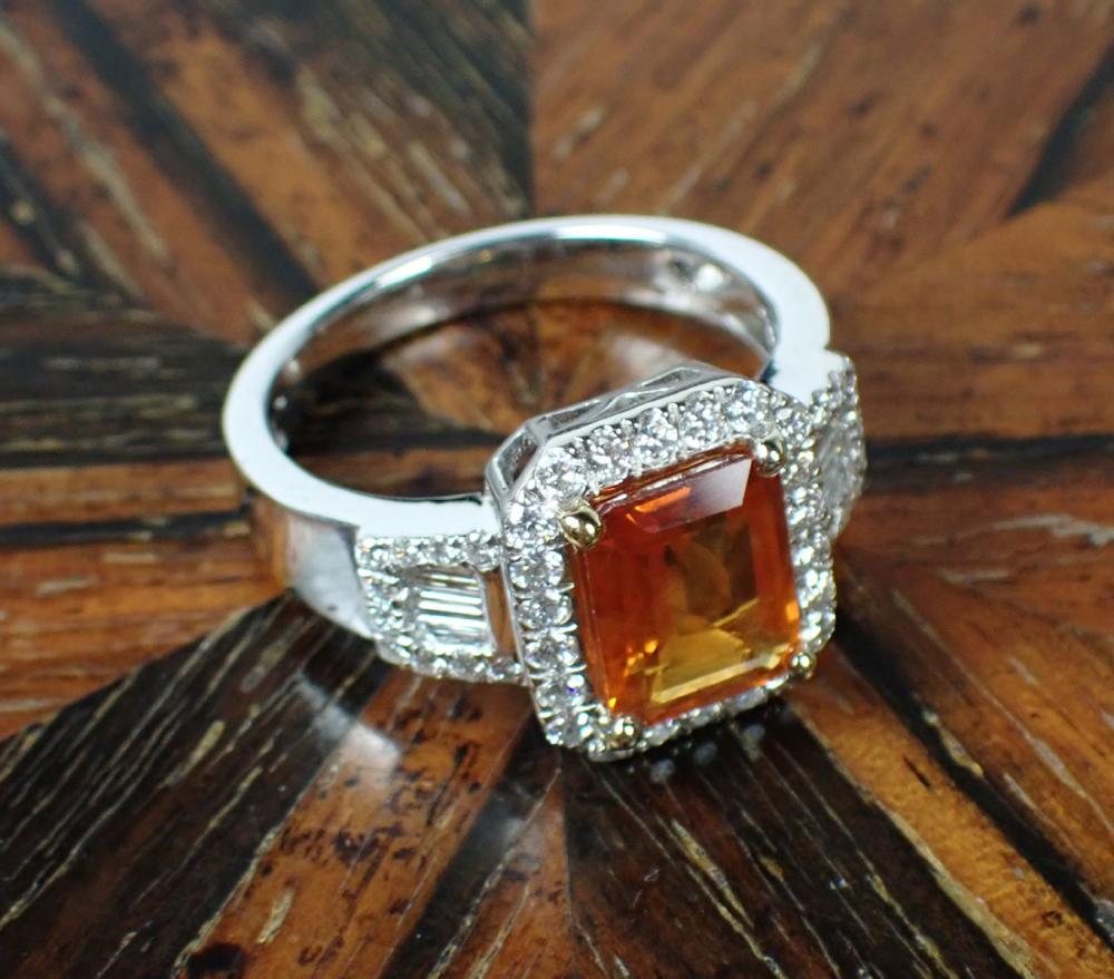 Appraisal: ORANGE SAPPHIRE DIAMOND AND FOURTEEN KARAT GOLD RING The k