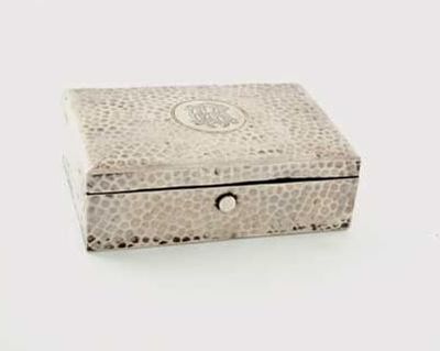 Appraisal: An Edwardian oblong stamp box with a hammered finish monogrammed