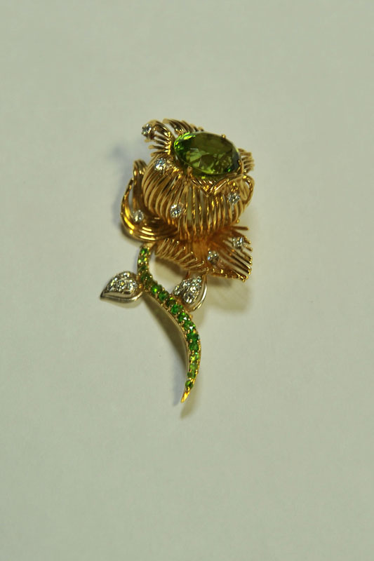 Appraisal: DIAMOND BROOCH Floriform brooch with diamond and green stones Marked