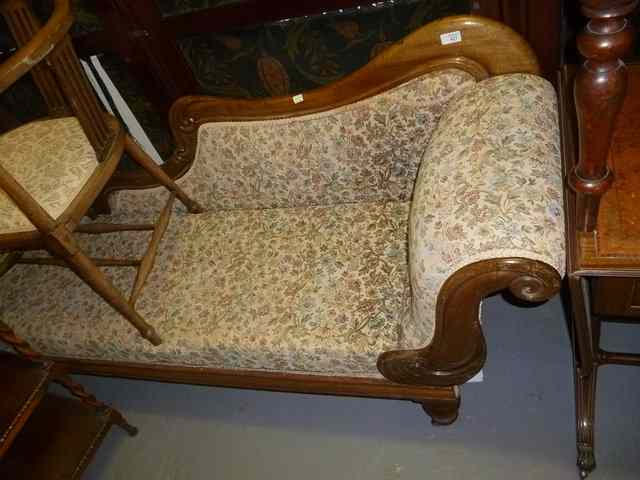 Appraisal: A MAHOGANY FRAMED CHAISE LONGUE with scrolled end and turned