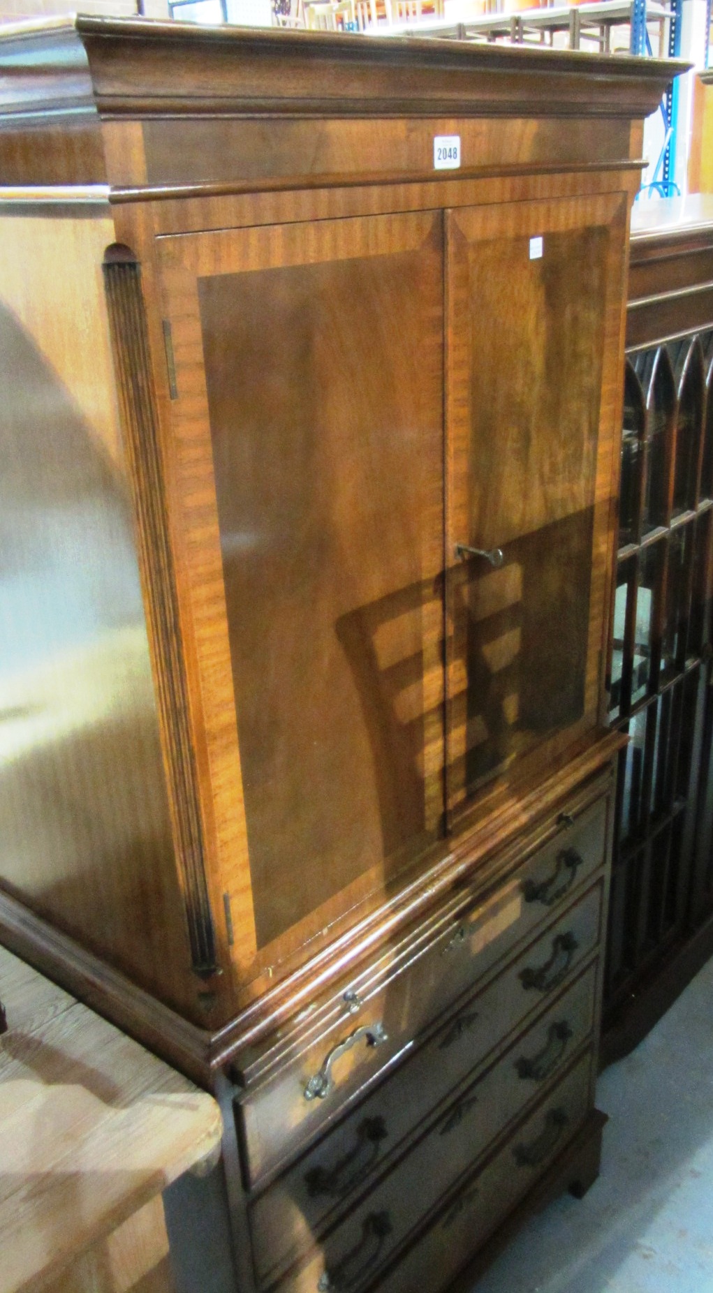 Appraisal: A th century mahogany cabinet on chest