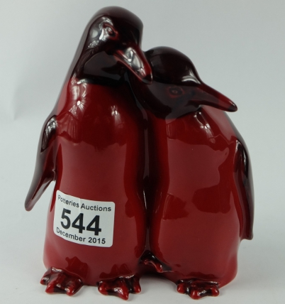 Appraisal: Royal Doulton pair Flambe cuddling penquins HN hairline crack to