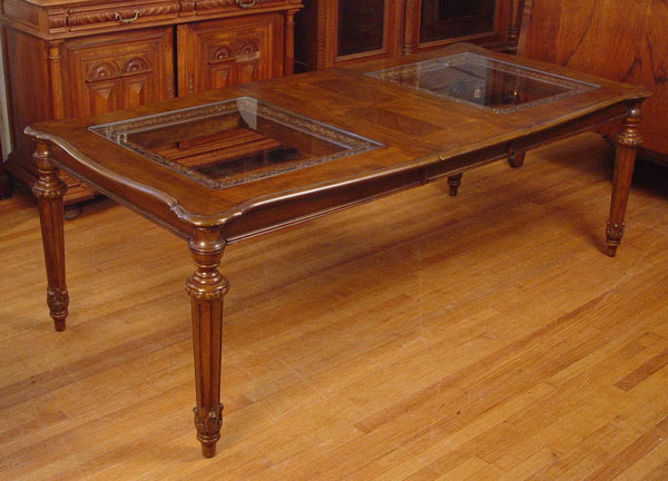 Appraisal: WALNUT DINING TABLE WITH GLASS INSERTS Recessed glass panels framed