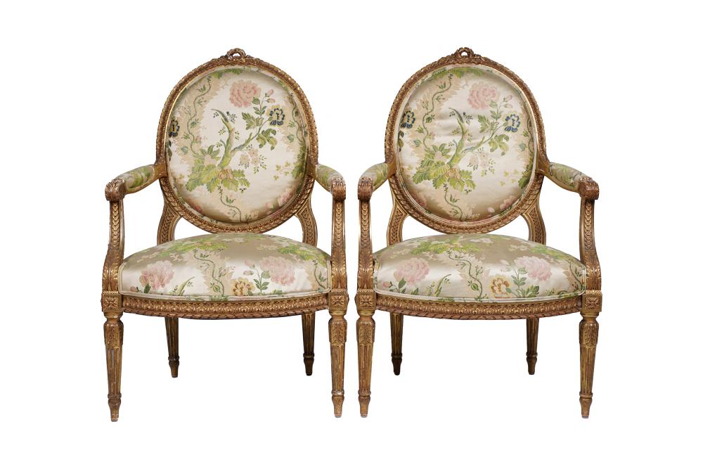 Appraisal: PAIR OF LOUIS XVI GILT CARVED FAUTEUILSwith silk upholstered seat