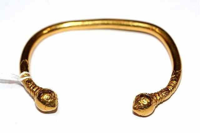 Appraisal: A HIGH CARAT GOLD TORQUE BANGLE with pear shaped finials