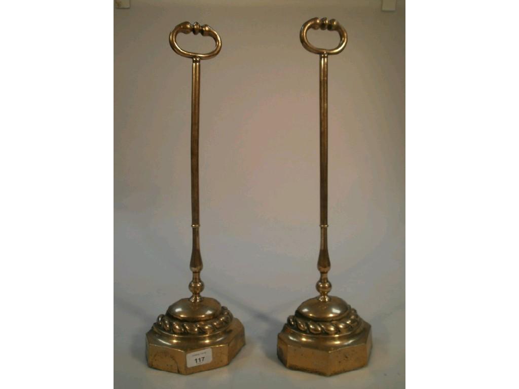 Appraisal: A pair of thC brass door stops with loop finials