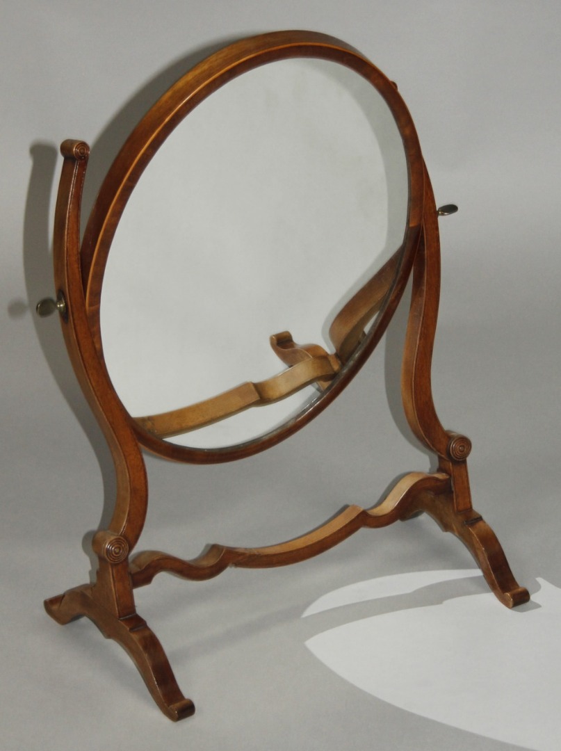 Appraisal: A thC mahogany framed table mirror the oval glass with