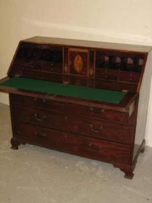 Appraisal: A GEORGE III MAHOGANY BUREAU the fall front opening to