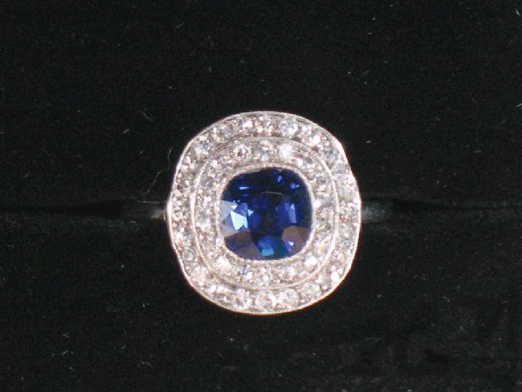 Appraisal: AN EDWARDIAN SAPPHIRE AND DIAMOND DRESS RING the central cushion-cut