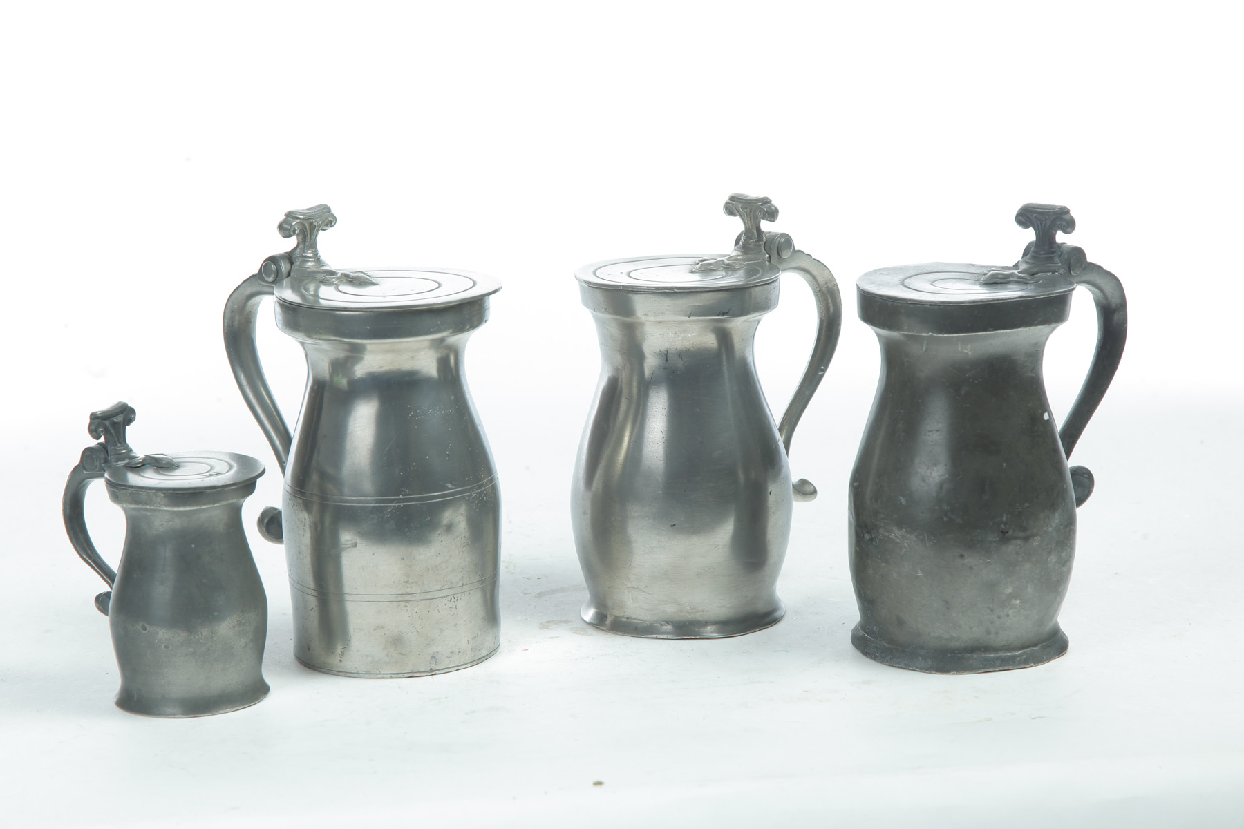 Appraisal: FOUR EUROPEAN PEWTER TANKARD MEASURES Nineteenth century Baluster form with