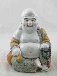 Appraisal: A finely enamelled ceramic figure of a seated Buddha cm