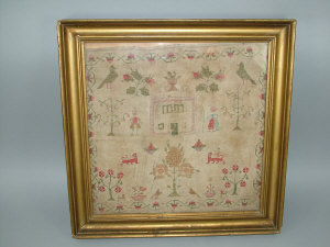 Appraisal: A sampler in coloured cottons circa depicting a house figures