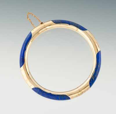 Appraisal: A Carved Lapis and Gold Bangle Bracelet Carved sections of