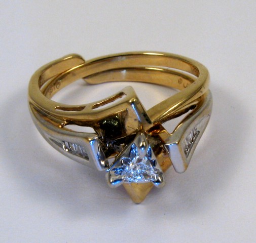 Appraisal: DIAMOND AND FOURTEEN KARAT GOLD RING with ring guard Set